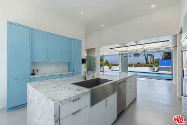 kitchen featuring dishwasher, sink, white cabinets, blue cabinetry, and a center island with sink