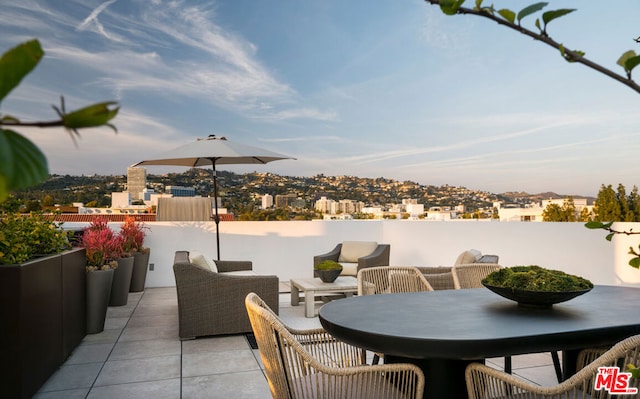 view of patio with an outdoor fireplace