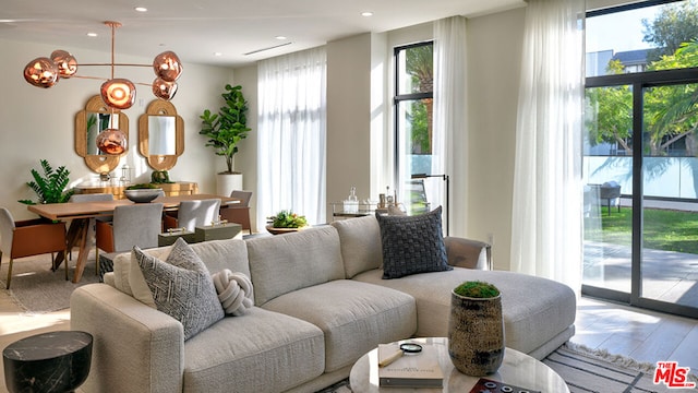 living room with wood-type flooring and a notable chandelier