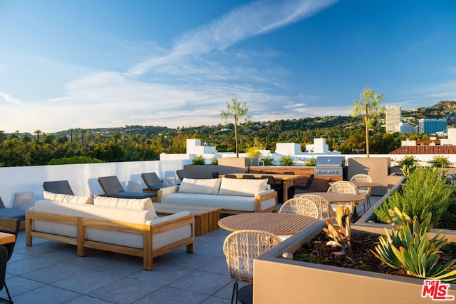 view of patio with an outdoor kitchen, outdoor lounge area, and grilling area