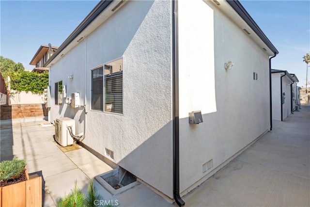 view of property exterior with a patio area and ac unit