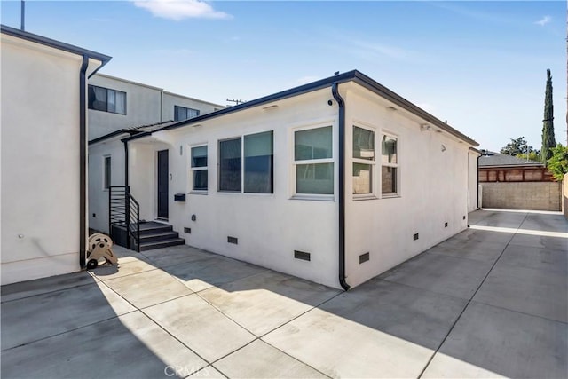 view of property exterior with a patio