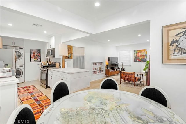 dining space featuring stacked washer and clothes dryer