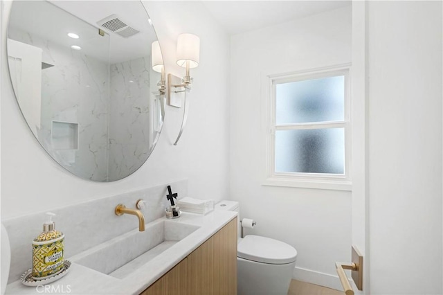 bathroom with vanity and toilet