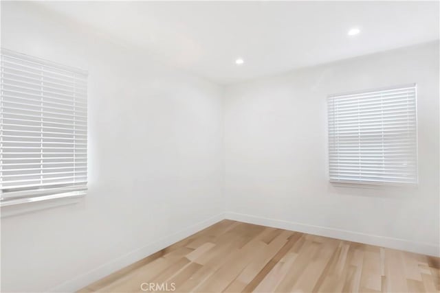 spare room featuring light wood-type flooring