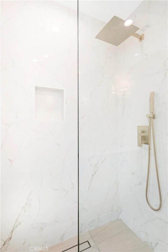 bathroom with tiled shower