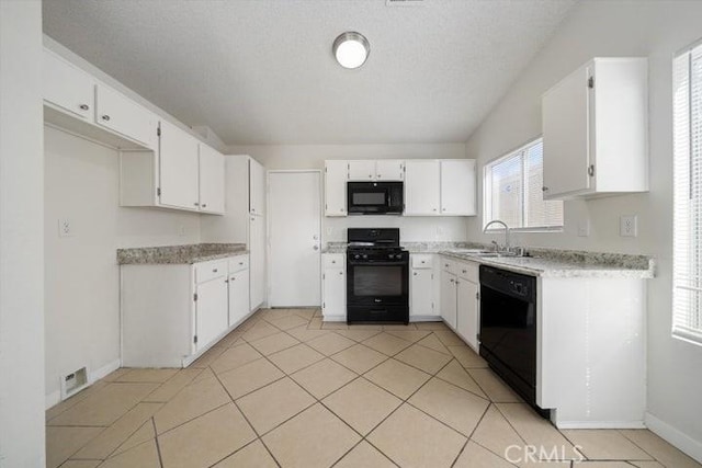 kitchen with sink, white cabinetry, black appliances, a textured ceiling, and light tile patterned flooring