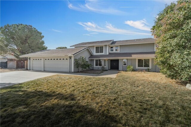 front facade featuring a garage and a front yard