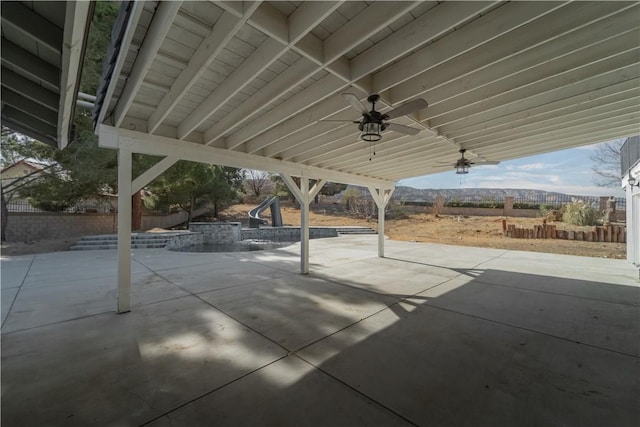 view of patio with a pool, a fenced backyard, and a ceiling fan