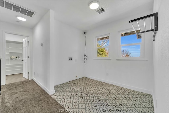 laundry area with visible vents and baseboards