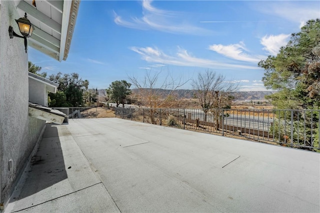 view of patio featuring fence and a mountain view