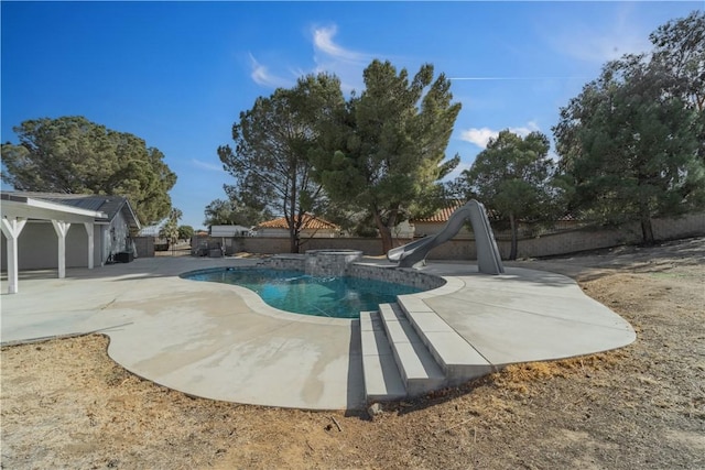 view of pool featuring a patio area, a fenced in pool, a water slide, and a fenced backyard