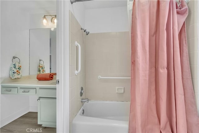 full bathroom with shower / bath combo with shower curtain, wood finished floors, and vanity