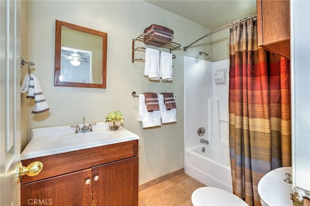 full bathroom featuring tile patterned floors, toilet, a ceiling fan, shower / tub combo with curtain, and vanity