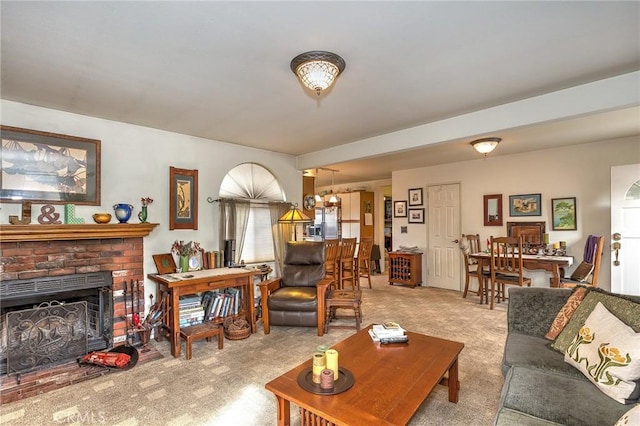 living room with light colored carpet and a brick fireplace