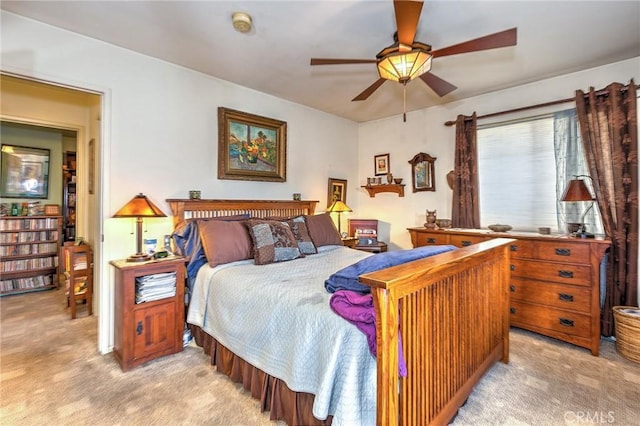 bedroom featuring light carpet and ceiling fan