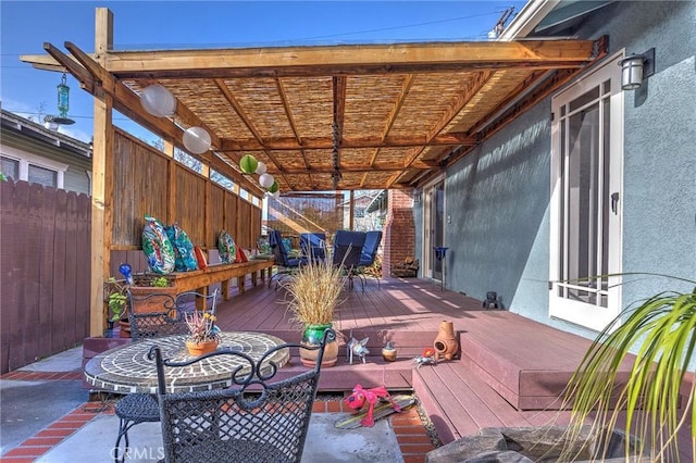 wooden terrace with fence and outdoor dining area