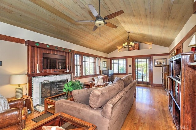 living room with wood ceiling, a fireplace, ceiling fan with notable chandelier, vaulted ceiling, and light wood-type flooring