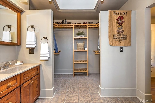bathroom featuring baseboards and vanity