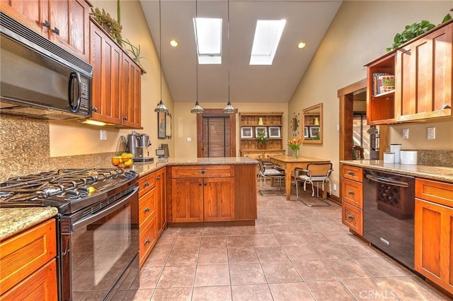 kitchen featuring black appliances, hanging light fixtures, light tile patterned floors, light stone counters, and kitchen peninsula