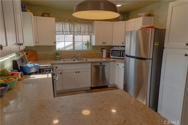 kitchen featuring sink, white cabinets, and appliances with stainless steel finishes