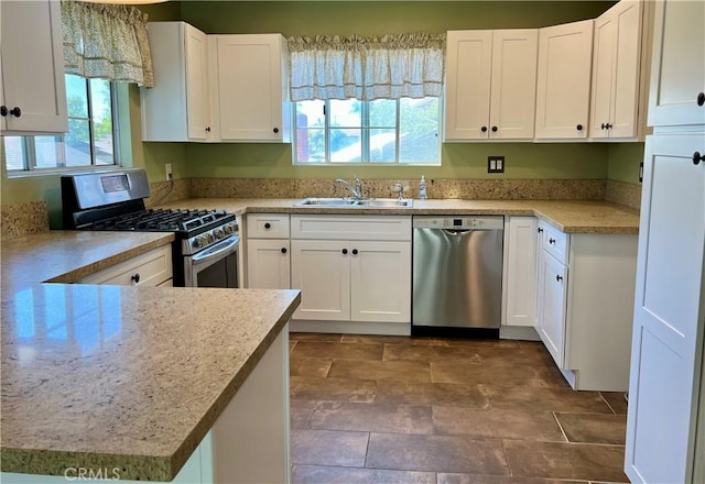 kitchen featuring white cabinets, a sink, and appliances with stainless steel finishes