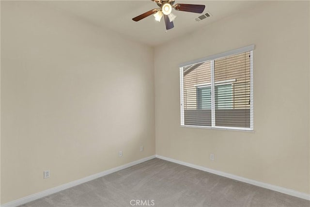 carpeted empty room featuring ceiling fan