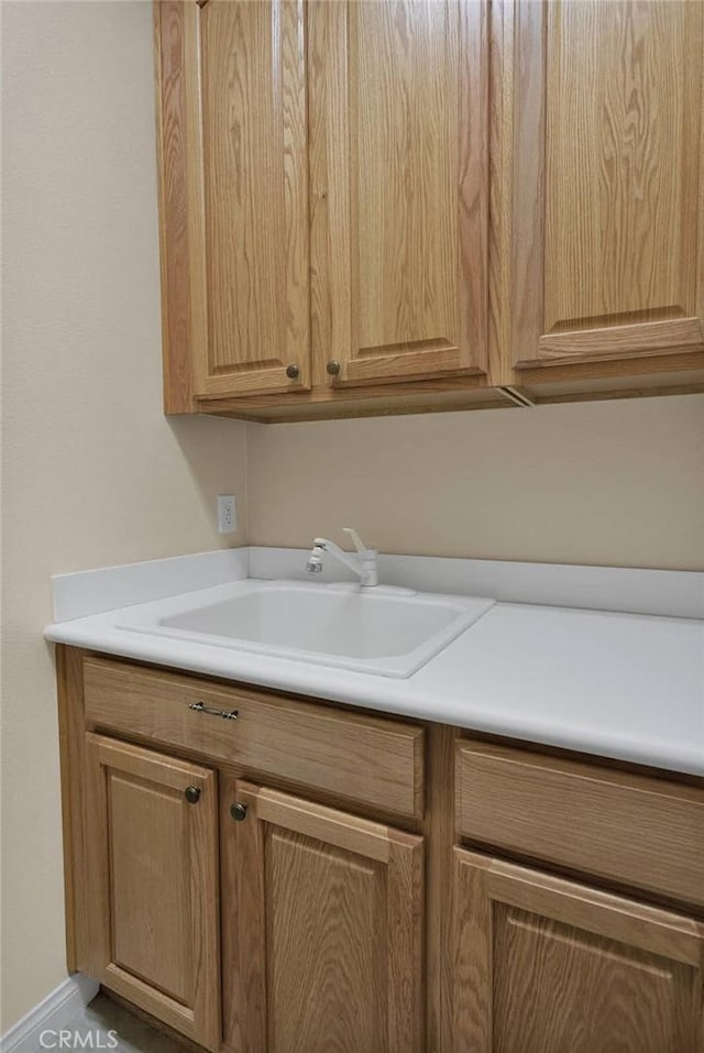 clothes washing area with sink