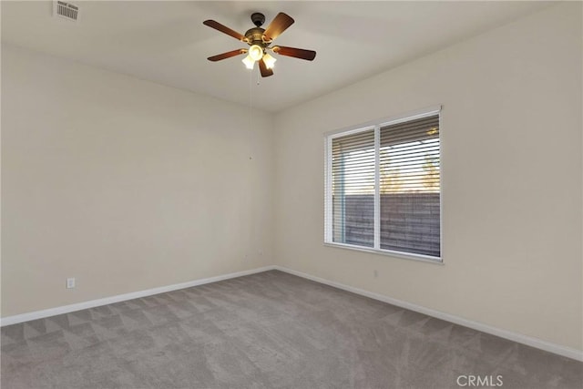 unfurnished room with light colored carpet and ceiling fan