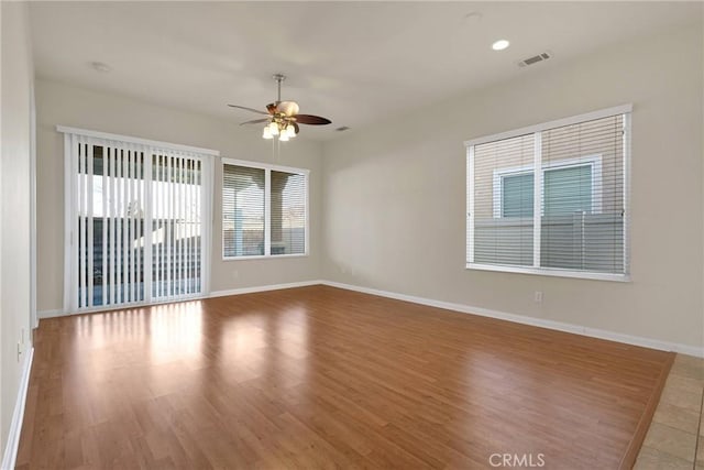 spare room featuring wood-type flooring and ceiling fan