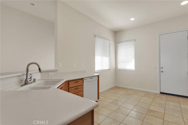 kitchen featuring dishwasher, sink, kitchen peninsula, and light tile patterned floors