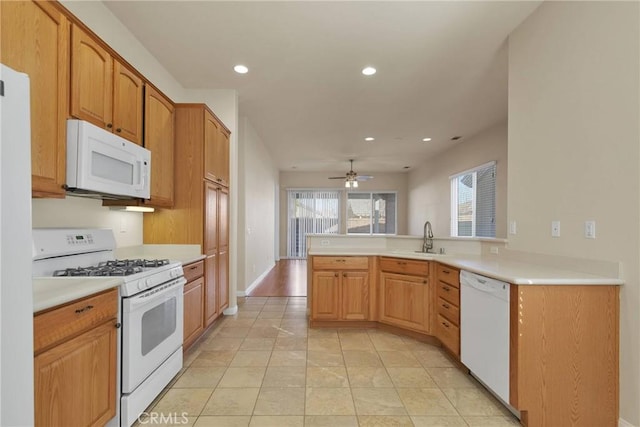 kitchen with sink, light tile patterned floors, white appliances, ceiling fan, and kitchen peninsula