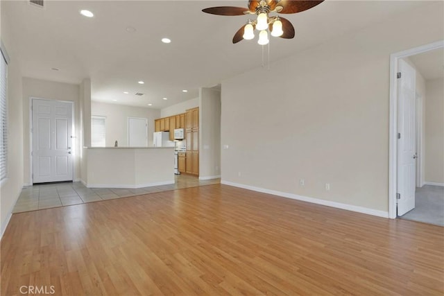 unfurnished living room featuring light hardwood / wood-style floors and ceiling fan