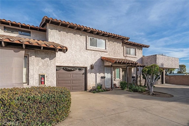 mediterranean / spanish house with a garage