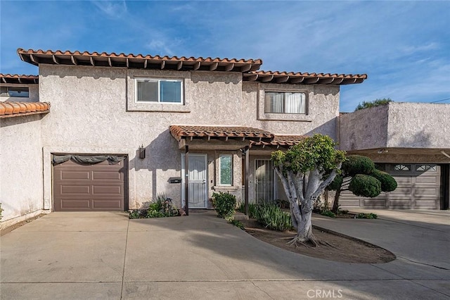 mediterranean / spanish-style home with a garage