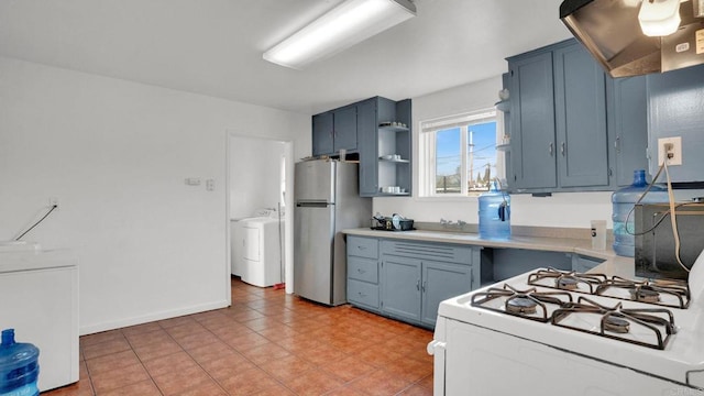 kitchen with stainless steel refrigerator, ventilation hood, blue cabinetry, and gas range gas stove