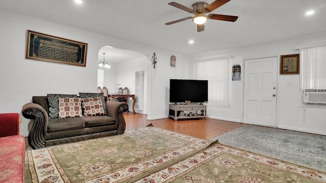 living room featuring cooling unit and ceiling fan