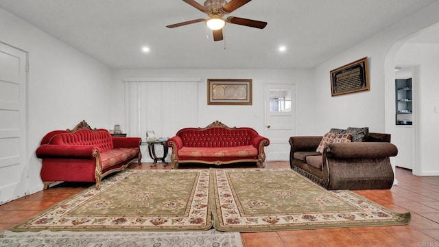 living room with tile patterned floors and ceiling fan