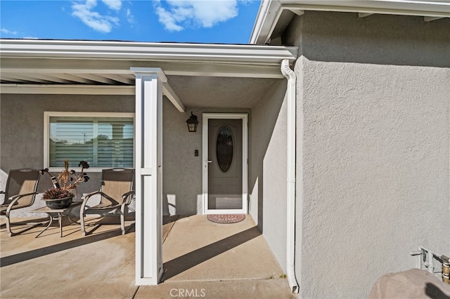 property entrance with a patio area