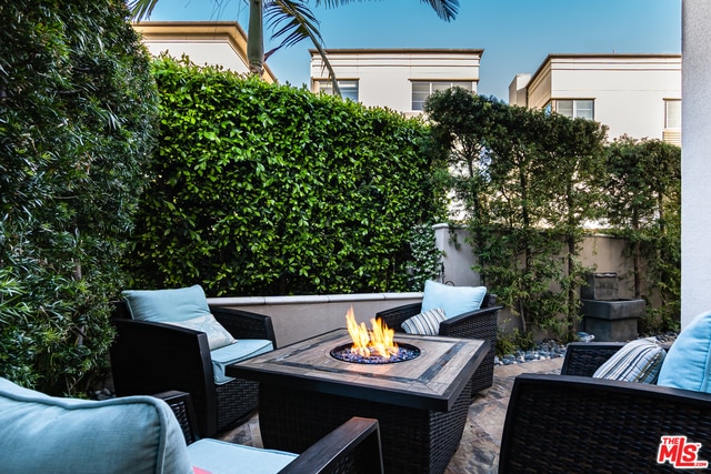 view of patio featuring an outdoor living space with a fire pit