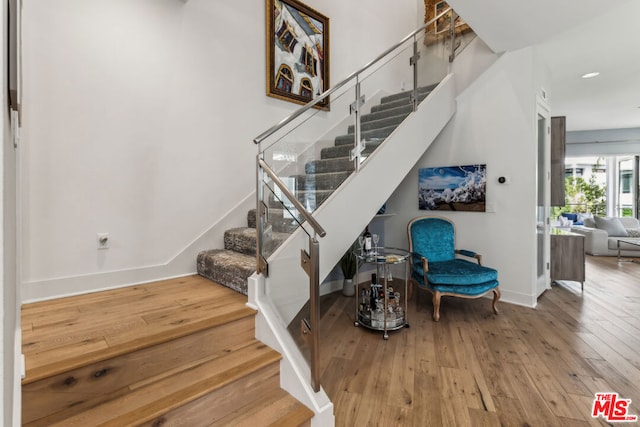 stairs with wood-type flooring