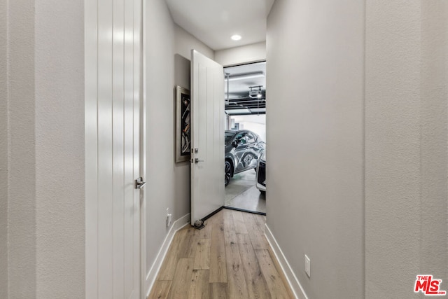 hall with light hardwood / wood-style floors