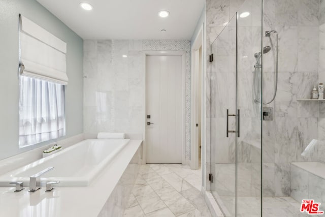 bathroom with separate shower and tub