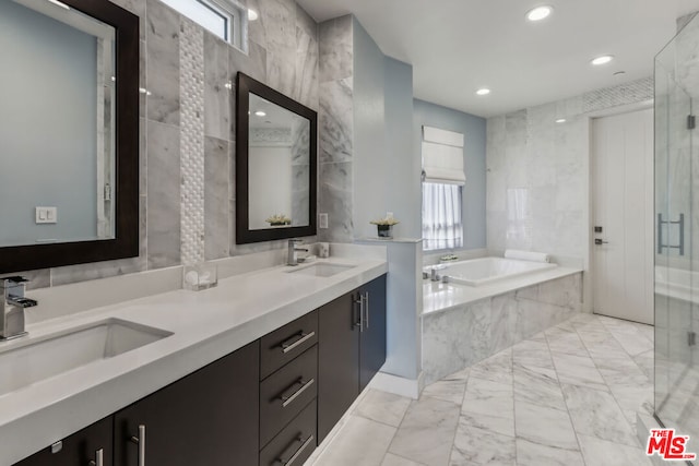 bathroom with vanity, separate shower and tub, and tile walls