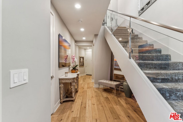 staircase with wood-type flooring