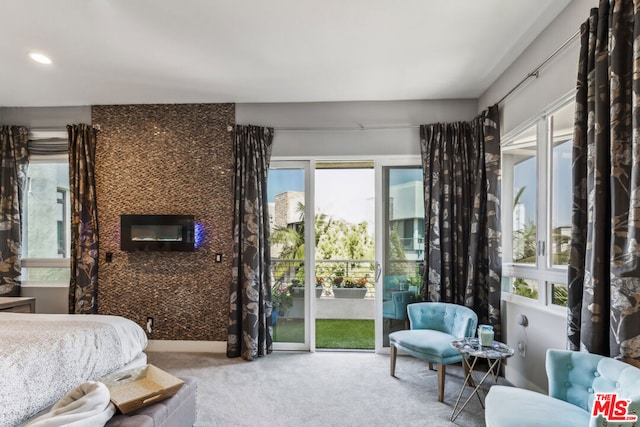 bedroom featuring carpet floors, access to outside, and a fireplace