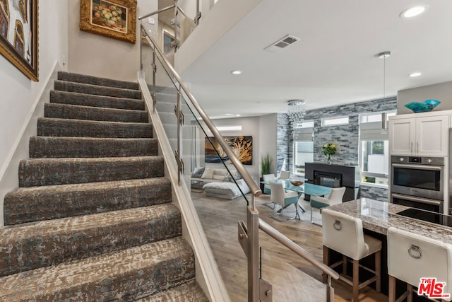 staircase with hardwood / wood-style flooring