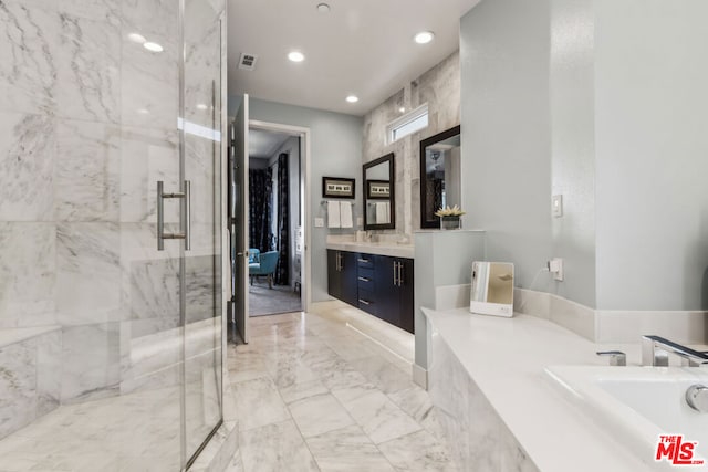 bathroom featuring vanity and a shower with shower door