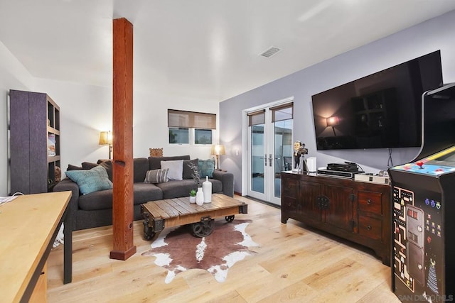 living room with french doors and light hardwood / wood-style flooring