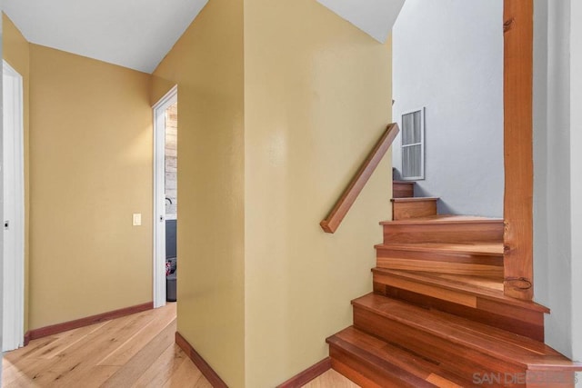 stairway featuring hardwood / wood-style floors